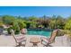 Beautiful pool area with chairs, desert landscaping and blooming vegetation with mountain views at 19947 N 94Th Way, Scottsdale, AZ 85255