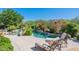 Resort-style pool area with lounge chairs and lush tropical landscaping perfect for relaxing at 19947 N 94Th Way, Scottsdale, AZ 85255