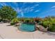 Backyard pool area surrounded by lush landscaping and desert foliage at 19947 N 94Th Way, Scottsdale, AZ 85255