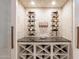 Custom wine storage with display shelves, countertop and cubbies for ample bottle storage at 19947 N 94Th Way, Scottsdale, AZ 85255