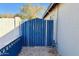 Blue metal gate at the back, providing access with a light-colored gravel ground at 2022 W Aster Dr, Phoenix, AZ 85029