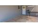 Covered patio area with concrete floor, painted brick wall, and convenient door access at 2022 W Aster Dr, Phoenix, AZ 85029