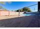 Backyard featuring a pool area, shed, and shaded pergola for outdoor enjoyment at 2022 W Aster Dr, Phoenix, AZ 85029