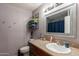Bright bathroom showcasing single vanity, framed mirror, and coordinated towels at 2022 W Aster Dr, Phoenix, AZ 85029