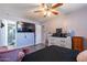 Bedroom with ceiling fan, tv and closet, offering comfort and style with ample space for personal belongings at 2022 W Aster Dr, Phoenix, AZ 85029