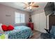 Bedroom with ceiling fan, closet and mini fridge, offering comfort and style, perfect for relaxation at 2022 W Aster Dr, Phoenix, AZ 85029