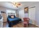 Cozy bedroom features a comfortable bed, ceiling fan, closet and natural light, perfect for relaxation at 2022 W Aster Dr, Phoenix, AZ 85029