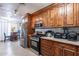 Modern kitchen with stainless steel appliances, granite countertops, and wood cabinetry at 2022 W Aster Dr, Phoenix, AZ 85029