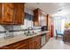 Well-lit kitchen with stainless steel appliances, wood cabinets and tile backsplash, great for cooking and entertaining at 2022 W Aster Dr, Phoenix, AZ 85029