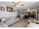 Spacious living room featuring a sectional sofa, tile flooring, and tasteful wall decor at 2022 W Aster Dr, Phoenix, AZ 85029