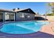Inviting pool area in backyard with ample lounge space and well-maintained landscaping at 2022 W Aster Dr, Phoenix, AZ 85029