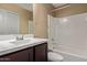 Bathroom showcasing a vanity, toilet, and shower-tub combination with tiled walls at 240 W Juniper Ave # 1211, Gilbert, AZ 85233