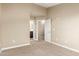Neutral bedroom with carpet, showcasing an open doorway to an ensuite bathroom at 240 W Juniper Ave # 1211, Gilbert, AZ 85233