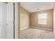 Unfurnished bedroom with carpet, featuring a closet and window for natural lighting at 240 W Juniper Ave # 1211, Gilbert, AZ 85233