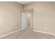 Bright bedroom with neutral walls and carpet, offering a view into the hallway at 240 W Juniper Ave # 1211, Gilbert, AZ 85233