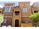 Inviting multi-level townhome showcasing a private balcony and a welcoming arched entryway at 240 W Juniper Ave # 1211, Gilbert, AZ 85233