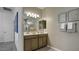 Bathroom with double sinks, a large mirror, and modern fixtures, offering convenience and style at 24066 W Cocopah St, Buckeye, AZ 85326