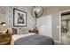 Cozy bedroom with patterned wallpaper, soft lighting, and comfortable bedding, creating a warm and inviting space at 24066 W Cocopah St, Buckeye, AZ 85326