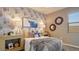 Chic bedroom featuring decorative wallpaper, stylish decor, and a cozy bed, exuding modern charm and comfort at 24066 W Cocopah St, Buckeye, AZ 85326