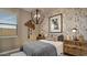 Charming bedroom with unique wallpaper, stylish furniture, and cozy lighting for a relaxed atmosphere at 24066 W Cocopah St, Buckeye, AZ 85326