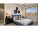 Bright bedroom with a cozy bed, stylish decor, and ample natural light streaming through the window at 24066 W Cocopah St, Buckeye, AZ 85326