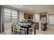Bright eat-in kitchen area featuring dark cabinets, an island and stainless steel appliances at 24066 W Cocopah St, Buckeye, AZ 85326