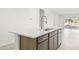 Kitchen island with stainless steel sink, dishwasher and white countertops at 24066 W Cocopah St, Buckeye, AZ 85326