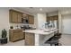 Spacious kitchen with an island, stainless steel appliances, and stylish counter stools at 24066 W Cocopah St, Buckeye, AZ 85326