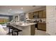 Modern kitchen with quartz countertops, stainless steel appliances, and breakfast bar seating four at 24066 W Cocopah St, Buckeye, AZ 85326