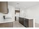 Contemporary kitchen showcasing an island with stainless steel dishwasher and ample cabinet space at 24066 W Cocopah St, Buckeye, AZ 85326