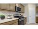 Modern kitchen featuring white subway tile, quartz countertops and stainless steel appliances at 24066 W Cocopah St, Buckeye, AZ 85326