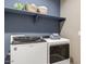 Well-equipped laundry room with modern washer and dryer and storage space at 24066 W Cocopah St, Buckeye, AZ 85326
