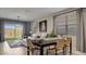 Open-concept living and dining area with stylish furnishings and bright natural light at 24066 W Cocopah St, Buckeye, AZ 85326