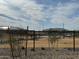 Community playground with tan base and black fence surrounded by decorative rocks and desert foliage at 24066 W Cocopah St, Buckeye, AZ 85326