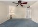 Bright bedroom features a ceiling fan, soft blue carpeting, and a welcoming atmosphere for restful nights at 2442 N 22Nd Ave, Phoenix, AZ 85009