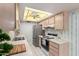 Well-lit kitchen with white appliances, ample counter space, and ceiling fan at 2442 N 22Nd Ave, Phoenix, AZ 85009