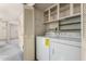 Convenient laundry room features a stacked washer and dryer and built-in cabinets for storage at 2442 N 22Nd Ave, Phoenix, AZ 85009