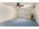 Cozy living room featuring blue carpet, lots of natural light and a ceiling fan for comfortable living at 2442 N 22Nd Ave, Phoenix, AZ 85009