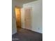Cozy bedroom with neutral carpet and built-in storage cabinets at 2530 W Berridge Ln # E111, Phoenix, AZ 85017