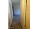 Hallway featuring a standard closet design and neutral tones creating a relaxing space at 2530 W Berridge Ln # E111, Phoenix, AZ 85017
