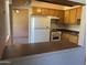Cozy kitchen view featuring classic appliances and cabinetry extending into the living space at 2530 W Berridge Ln # E111, Phoenix, AZ 85017