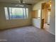 Bright living room featuring a large window offering natural light and views of the outdoor foliage at 2530 W Berridge Ln # E111, Phoenix, AZ 85017