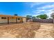 Large backyard with dirt, a covered patio, and a storage shed at 2802 W Butler Dr, Phoenix, AZ 85051