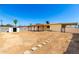 Expansive backyard with a large storage shed, covered patio, and stepping stones at 2802 W Butler Dr, Phoenix, AZ 85051