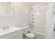 Bright bathroom featuring a shower-tub combo and single sink vanity with a white tile surround at 2802 W Butler Dr, Phoenix, AZ 85051