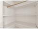 Walk-in closet with white shelving and a wooden clothes rod, providing ample storage space at 2802 W Butler Dr, Phoenix, AZ 85051