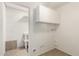 Bright laundry room with storage cabinets and utility sink at 2802 W Butler Dr, Phoenix, AZ 85051