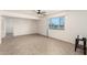 Bright living room with tile flooring, ceiling fan, and large window providing ample natural light at 2802 W Butler Dr, Phoenix, AZ 85051