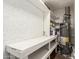 Utility room featuring shelving, a work bench, and a water heater at 2802 W Butler Dr, Phoenix, AZ 85051