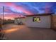 Exterior view of a home's backyard with a patio and an illuminated setting at 316 N Ironwood --, Mesa, AZ 85201
